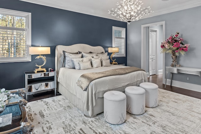 bedroom with ornamental molding, hardwood / wood-style floors, and a notable chandelier