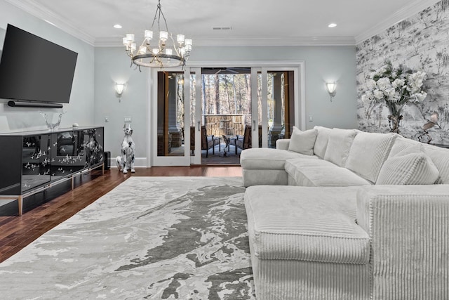 living room with dark hardwood / wood-style flooring, a notable chandelier, and ornamental molding