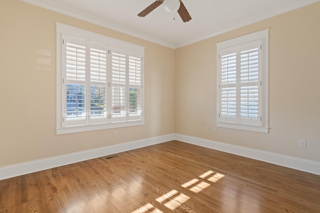 empty room featuring crown molding, ceiling fan, and wood-type flooring