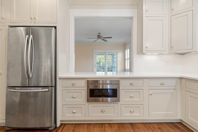 kitchen with crown molding, stainless steel appliances, light hardwood / wood-style flooring, and white cabinets