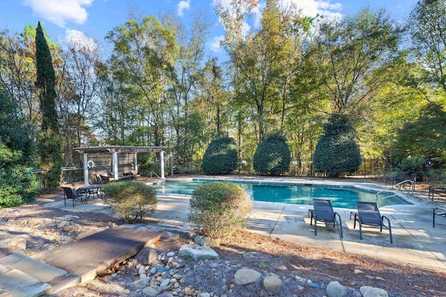 view of pool with a pergola and a patio