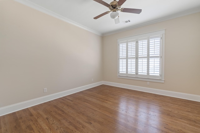 empty room featuring ornamental molding, wood-type flooring, and ceiling fan