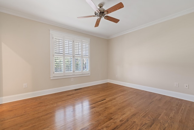 unfurnished room featuring hardwood / wood-style flooring, ornamental molding, and ceiling fan