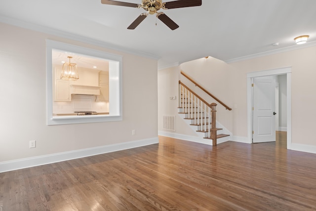 unfurnished living room with crown molding, dark wood-type flooring, and ceiling fan