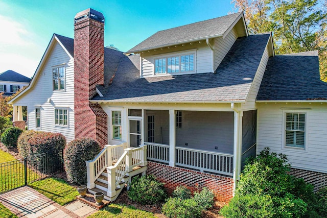 view of front of home featuring a sunroom