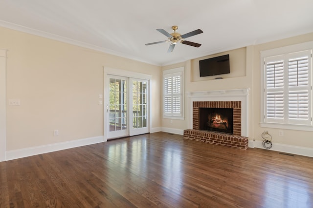 unfurnished living room with ceiling fan, ornamental molding, a fireplace, and dark hardwood / wood-style flooring