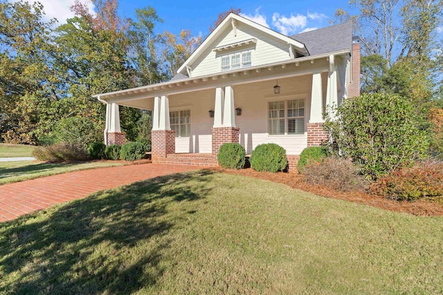 view of front of house featuring covered porch and a front lawn