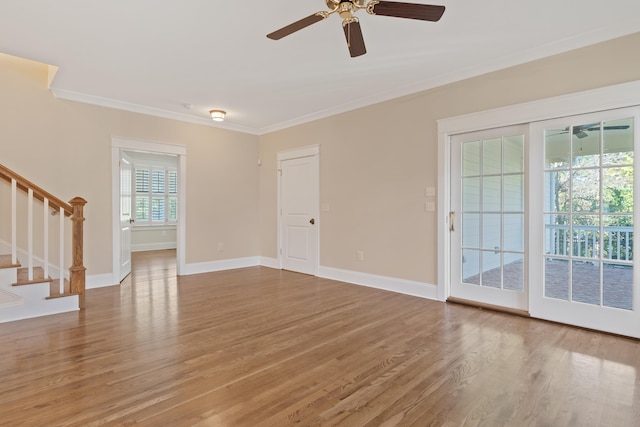 spare room with hardwood / wood-style floors, crown molding, and ceiling fan