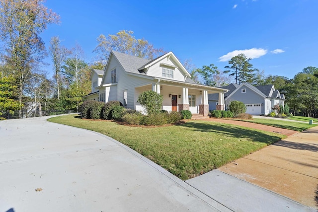 view of front of house with a porch, a garage, and a front yard