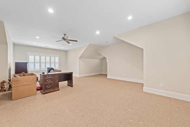 carpeted office space with ceiling fan