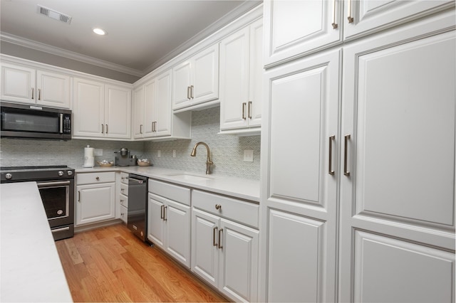 1031 Lockets Trl, Greensboro, GA 30642 - kitchen featuring white cabinetry, visible vents, a sink, and range with electric cooktop