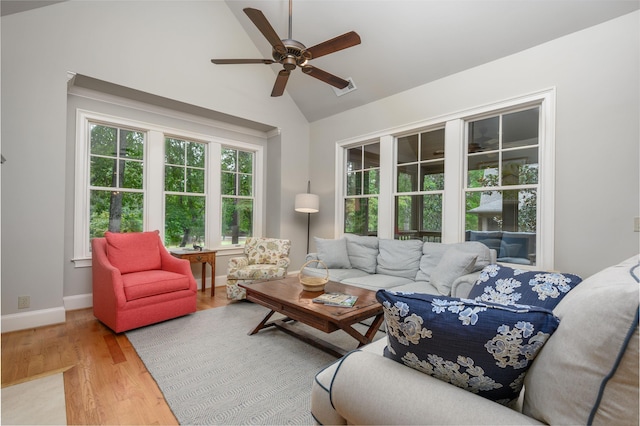 1031 Lockets Trl, Greensboro, GA 30642 - living area featuring wood finished floors, lofted ceiling, baseboards, visible vents, and ceiling fan