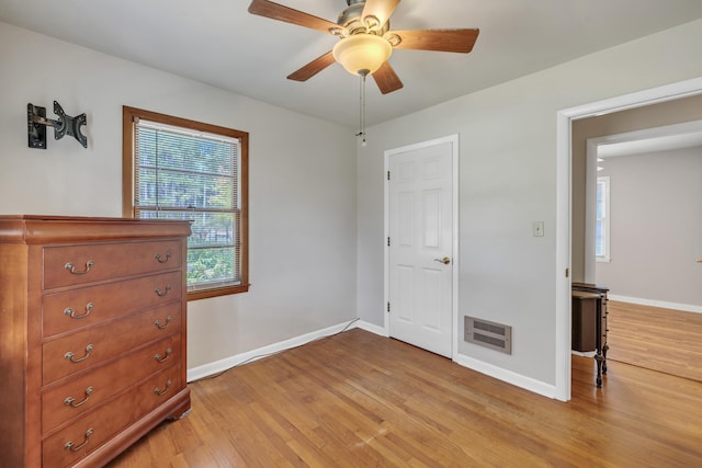 unfurnished bedroom featuring heating unit, ceiling fan, and light hardwood / wood-style flooring