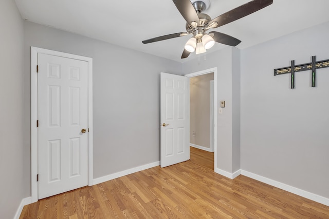 unfurnished bedroom with ceiling fan and light hardwood / wood-style floors