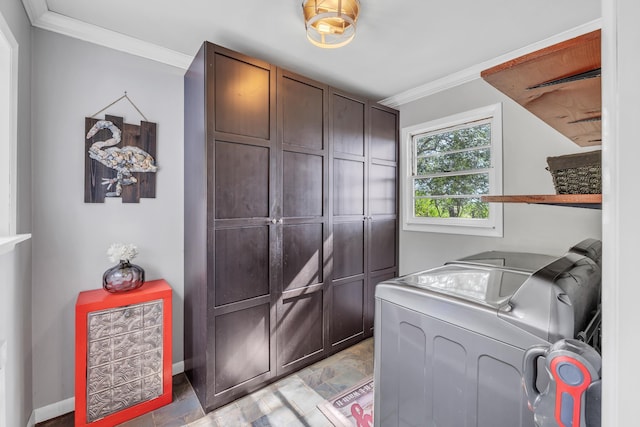 clothes washing area featuring separate washer and dryer, ornamental molding, and cabinets