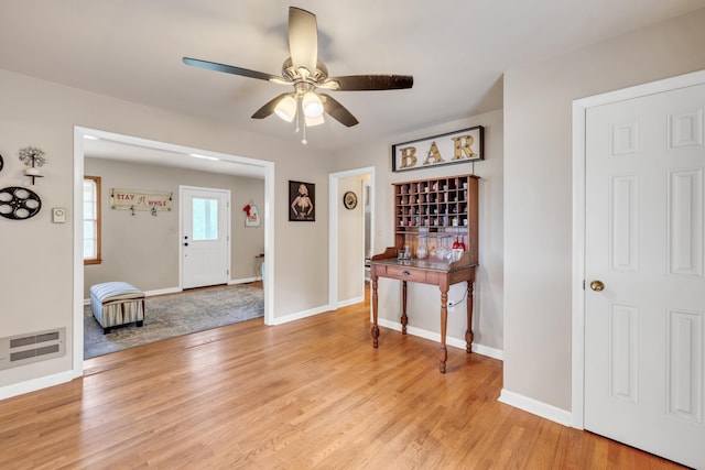 entryway with light hardwood / wood-style flooring and ceiling fan