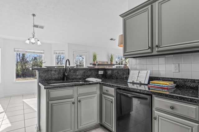 kitchen with dishwashing machine, visible vents, a sink, and gray cabinetry