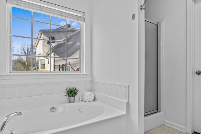 full bathroom with a garden tub, a shower with door, and tile patterned floors