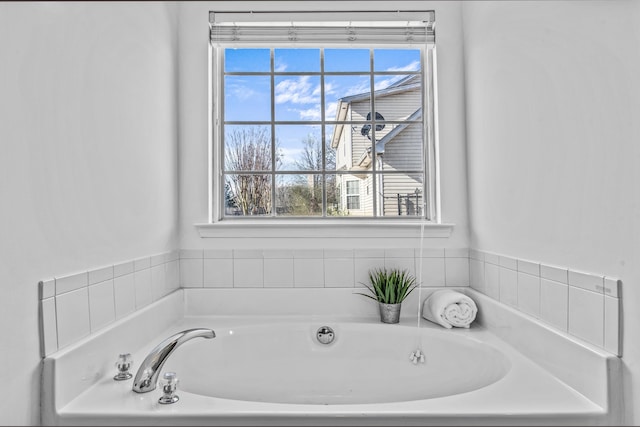 full bathroom featuring a garden tub and plenty of natural light