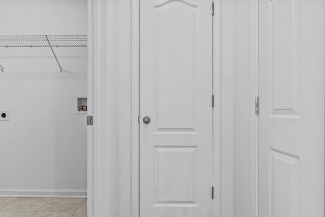 laundry room featuring laundry area, baseboards, hookup for an electric dryer, washer hookup, and light tile patterned flooring