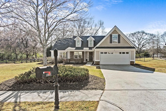 view of front facade with fence, a garage, stone siding, driveway, and a front lawn