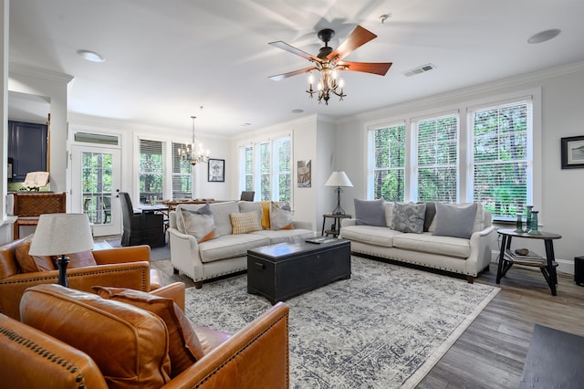 living room with crown molding, ceiling fan with notable chandelier, and hardwood / wood-style flooring