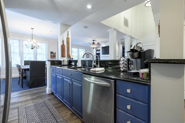 kitchen featuring blue cabinetry, sink, decorative light fixtures, stainless steel dishwasher, and dark hardwood / wood-style floors