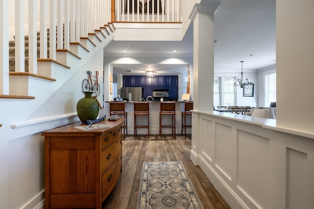 interior space with ornamental molding, dark wood-type flooring, and a chandelier