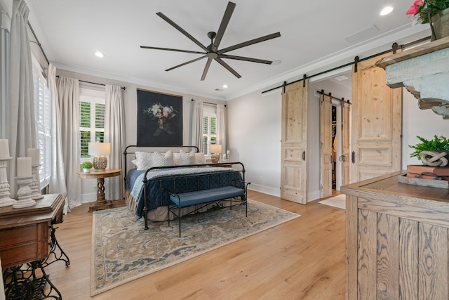 113 Daisy Trl, Milledgeville, GA 31061 - bedroom featuring ornamental molding, multiple windows, a barn door, and light wood-type flooring