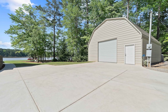 113 Daisy Trl, Milledgeville, GA 31061 - detached garage with driveway and a water view