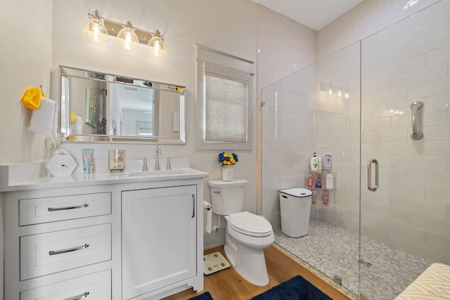 113 Daisy Trl, Milledgeville, GA 31061 - full bathroom with wood finished floors, a shower stall, toilet, and vanity