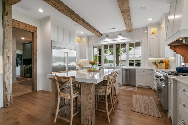 113 Daisy Trl, Milledgeville, GA 31061 - kitchen featuring premium appliances, beam ceiling, custom exhaust hood, and backsplash