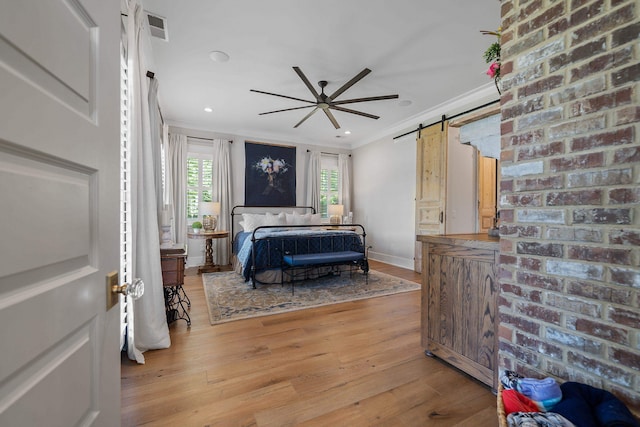 113 Daisy Trl, Milledgeville, GA 31061 - bedroom with ornamental molding, visible vents, a barn door, and light wood-type flooring
