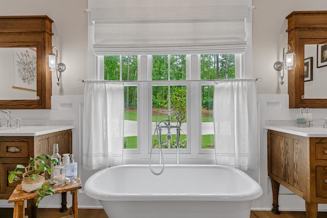 113 Daisy Trl, Milledgeville, GA 31061 - bathroom with a freestanding bath, wood finished floors, and vanity