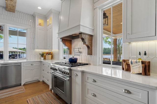 113 Daisy Trl, Milledgeville, GA 31061 - kitchen featuring light wood-type flooring, a healthy amount of sunlight, appliances with stainless steel finishes, and backsplash