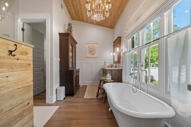 113 Daisy Trl, Milledgeville, GA 31061 - bathroom featuring a decorative wall, a freestanding bath, wooden ceiling, wood finished floors, and a notable chandelier