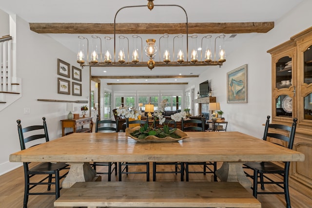 113 Daisy Trl, Milledgeville, GA 31061 - dining room with stairs, a notable chandelier, beam ceiling, and wood finished floors