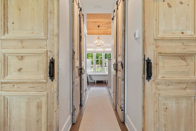 113 Daisy Trl, Milledgeville, GA 31061 - corridor with wood finished floors and a chandelier