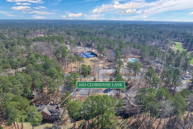 drone / aerial view featuring a forest view