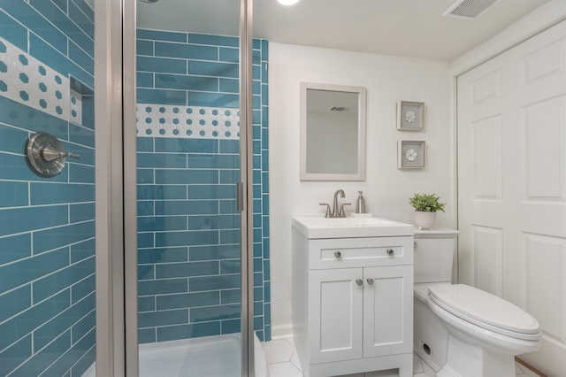 bathroom with visible vents, toilet, a stall shower, and vanity