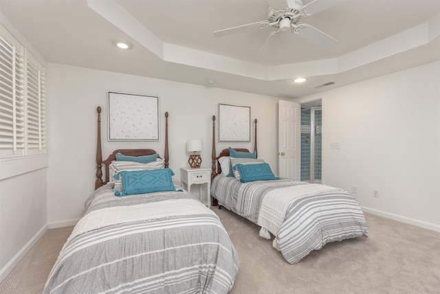 bedroom featuring light carpet, a raised ceiling, recessed lighting, baseboards, and ceiling fan