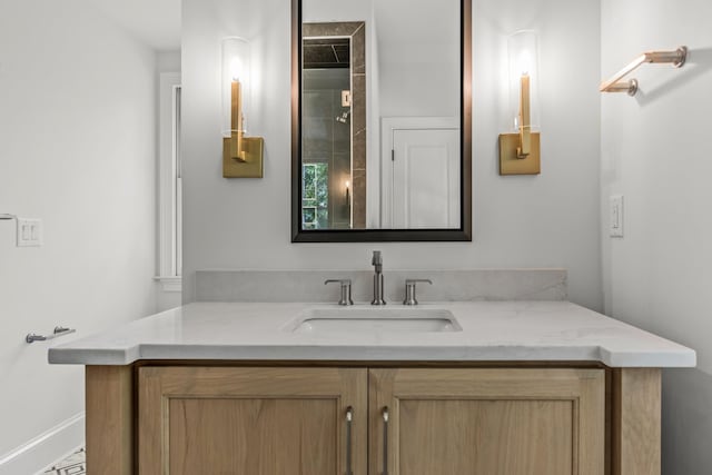 bathroom featuring baseboards and vanity