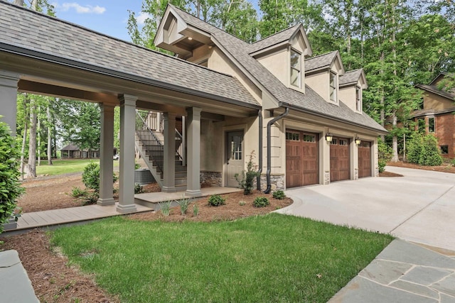 view of front of property with stone siding, driveway, stucco siding, stairway, and a shingled roof