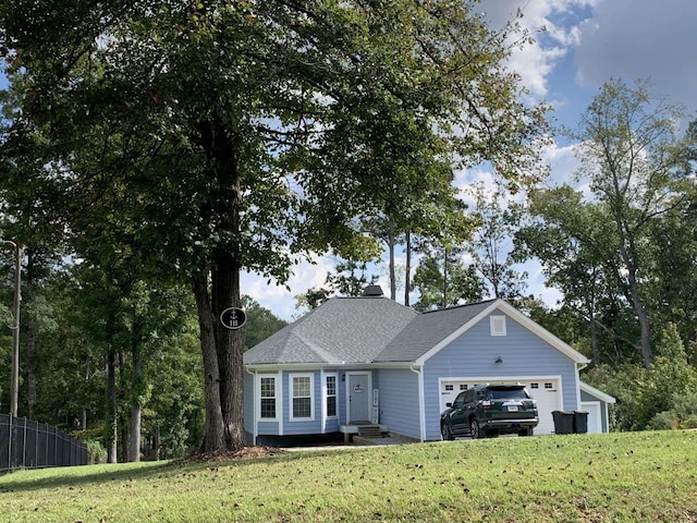 ranch-style home with entry steps, a front yard, a garage, and fence