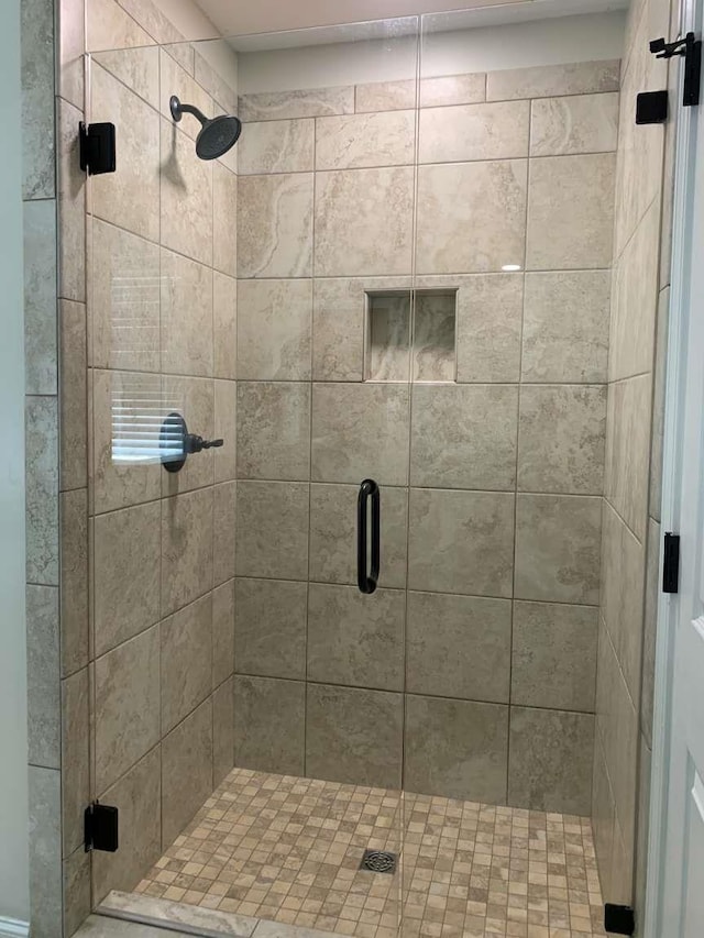 bathroom featuring a shower stall