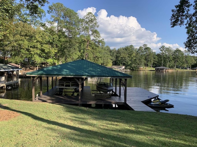 view of dock with a yard, a water view, and boat lift