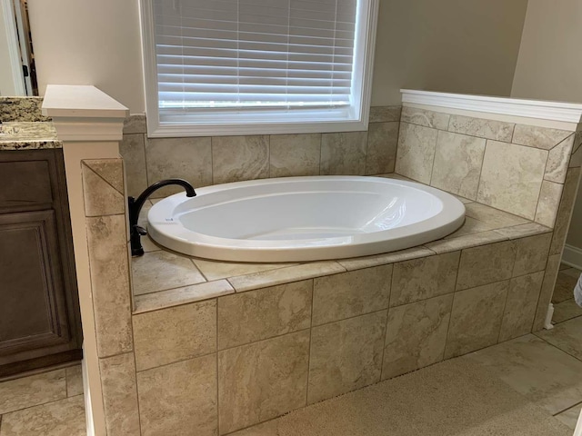 bathroom featuring vanity and a bath