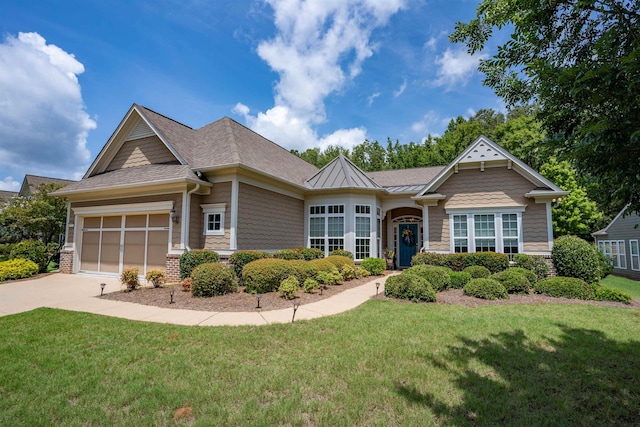 craftsman inspired home with a garage and a front lawn