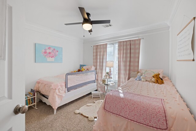 bedroom with ceiling fan, ornamental molding, and carpet