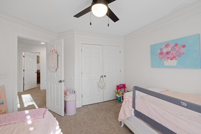 bedroom with crown molding, light carpet, ceiling fan, and a closet